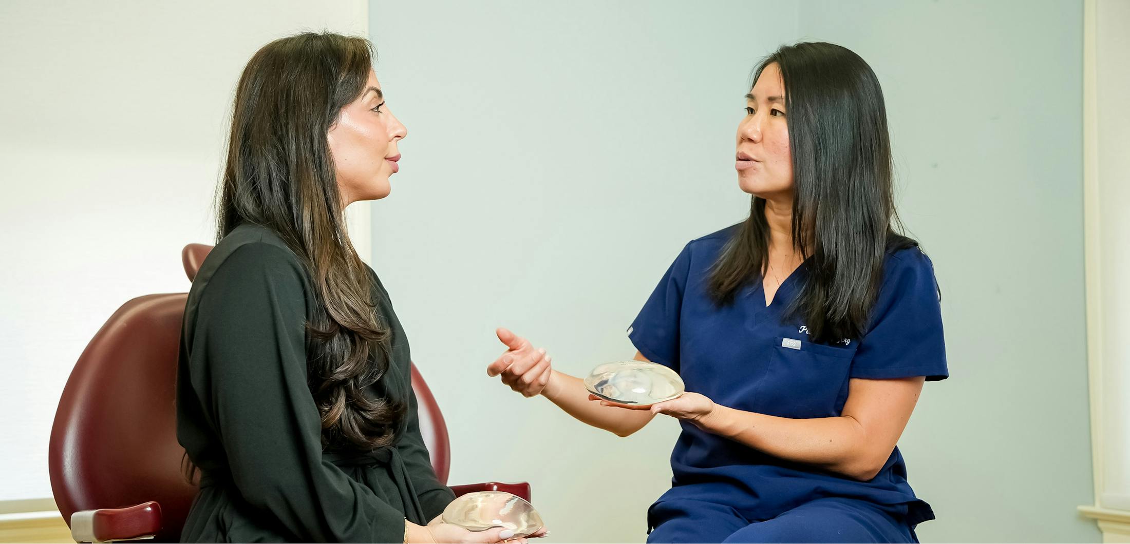 patient looking at her results in a handheld mirror