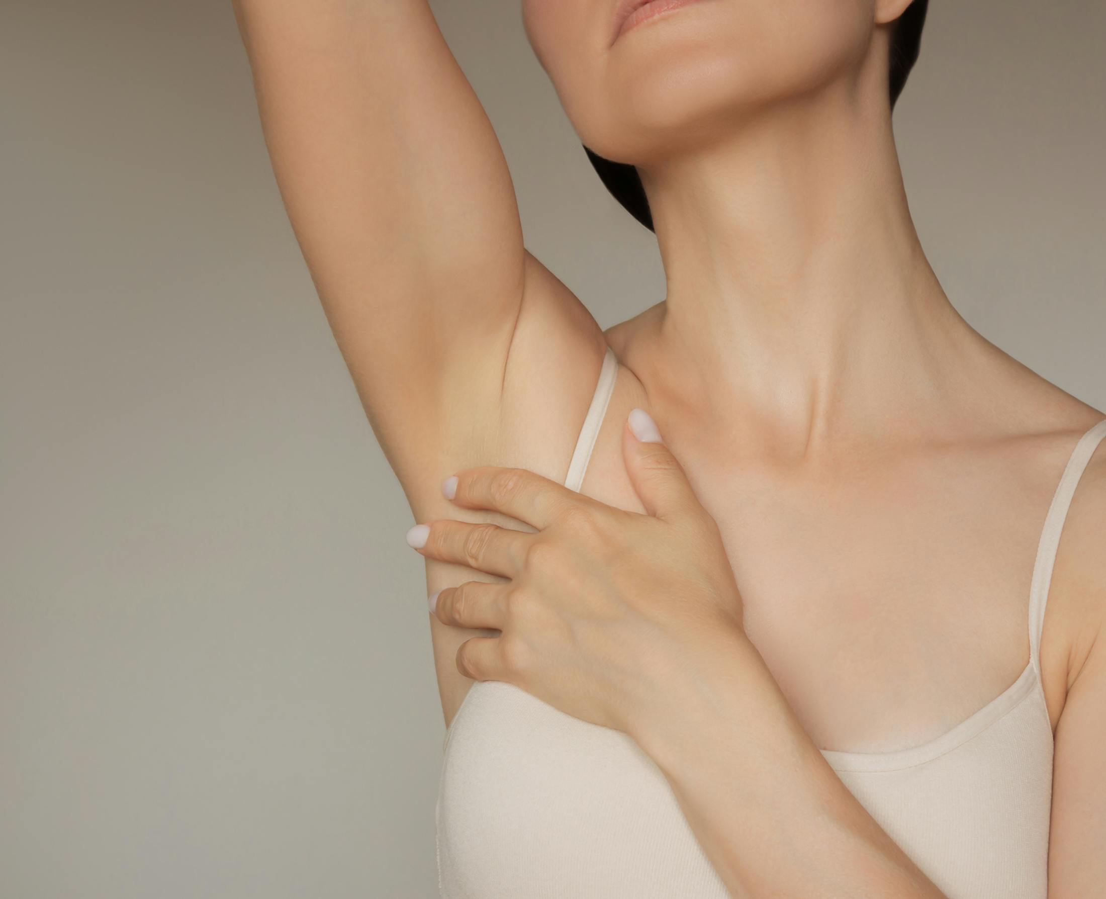 woman touching armpit