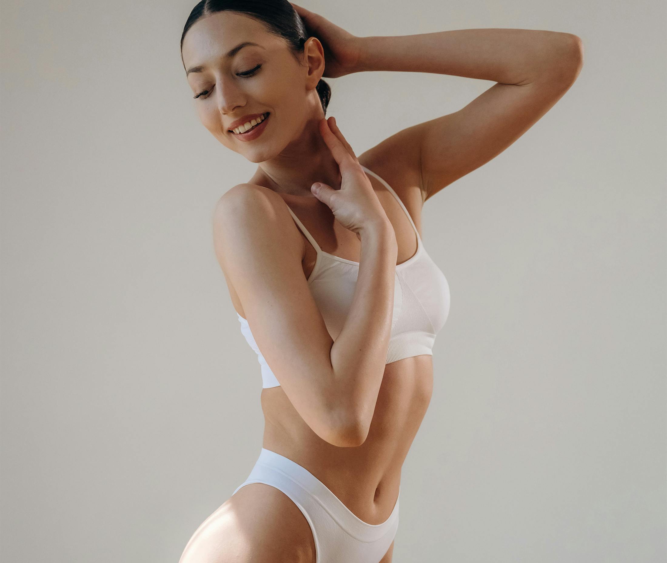 woman smiling touching face and neck