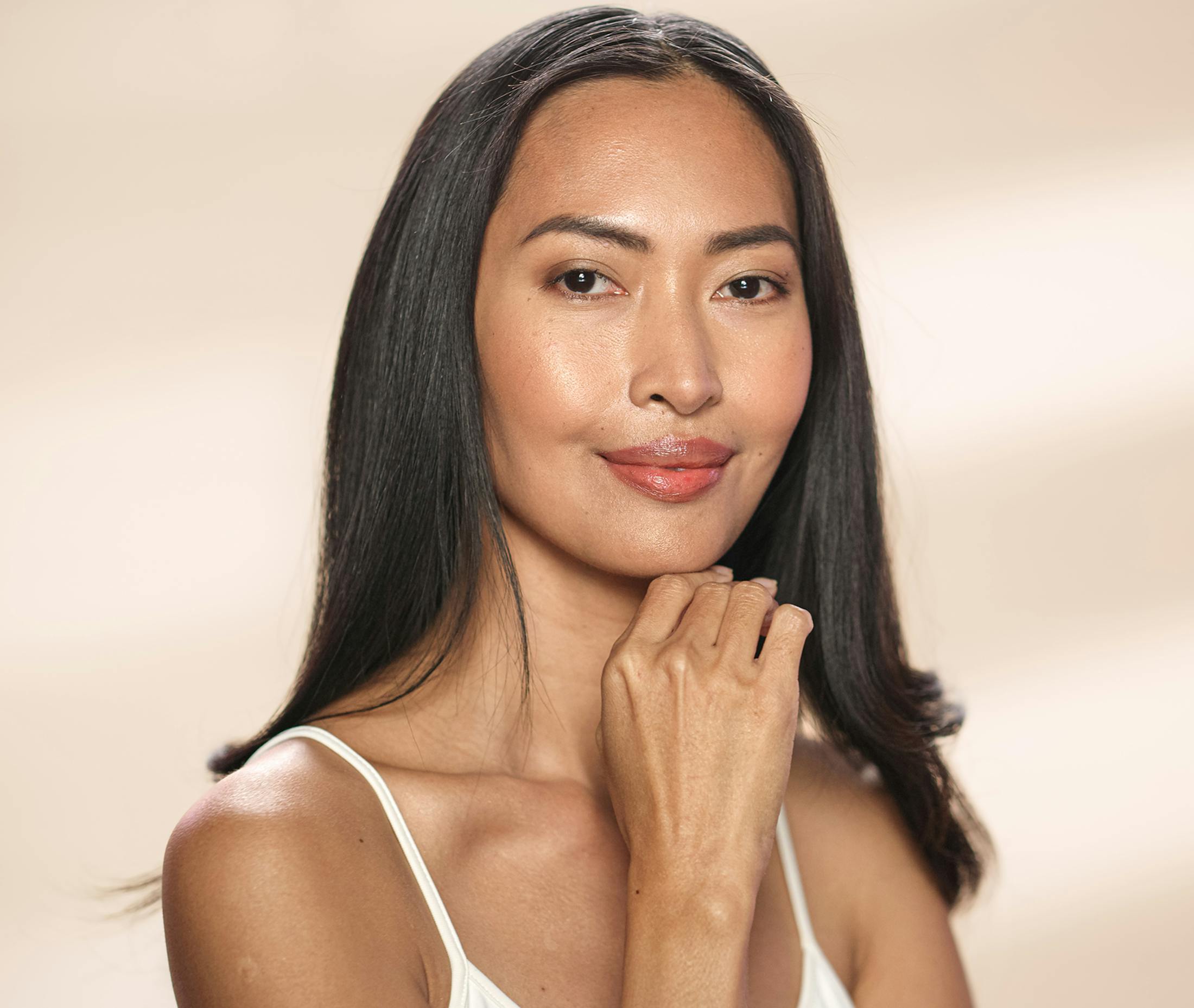 woman smiling with head in hands