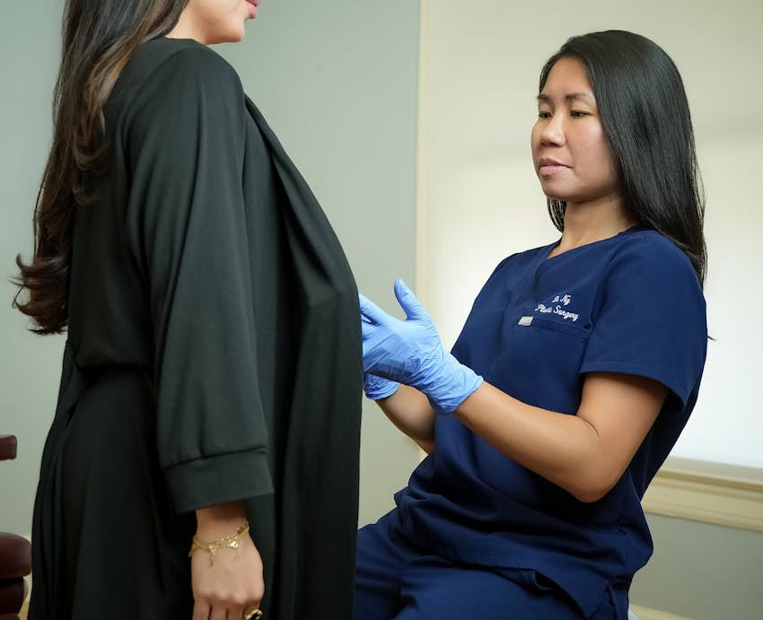 doctor inspecting woman in black dress