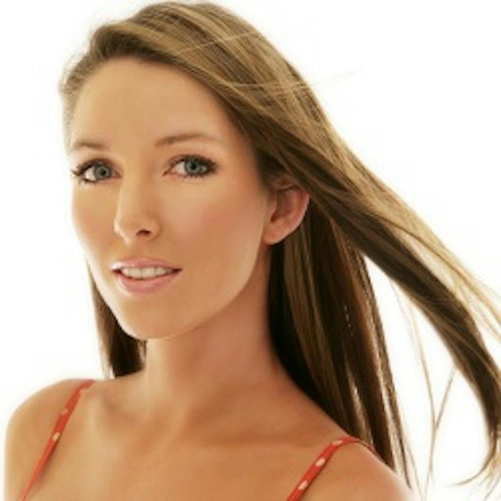 Woman smiling with wind blowing hair