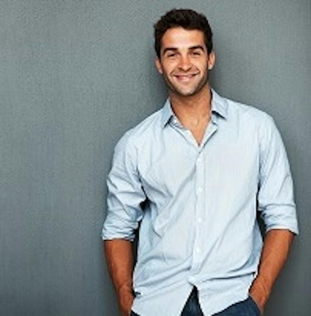 Man smiling wearing blue Button up