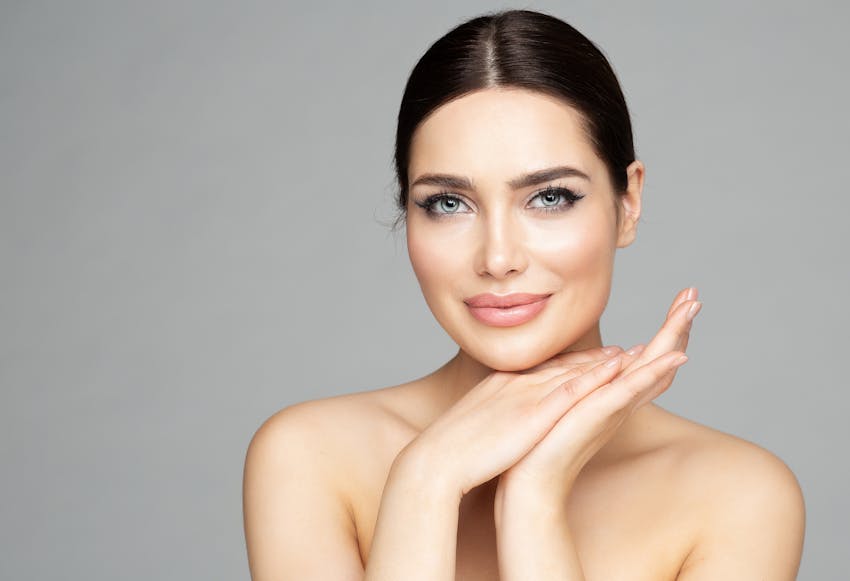 woman with with her hands together under her chin