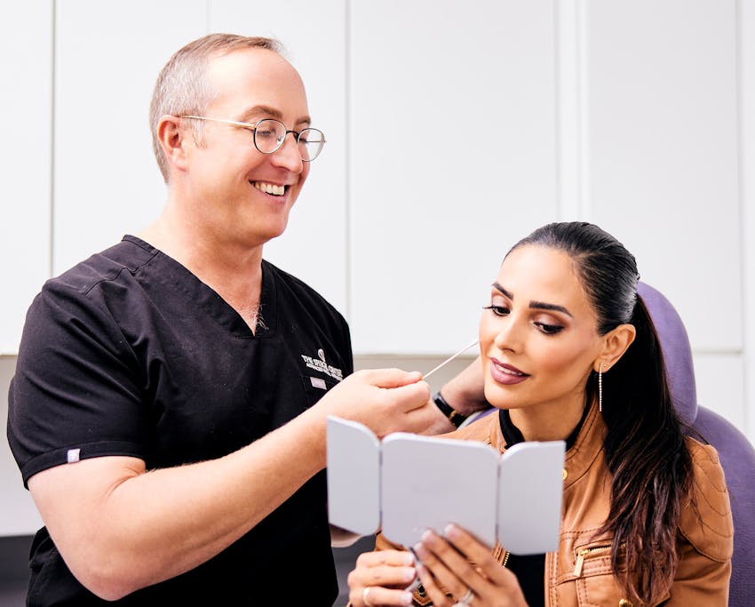 doctor with patient looking at her face