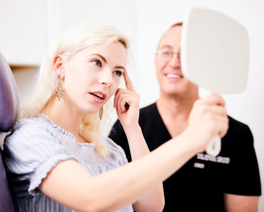 patient checking her brow bone with doctor