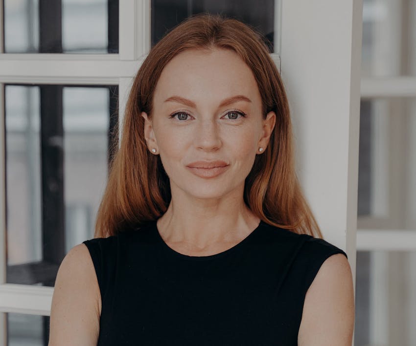 woman with orange hair looking forward