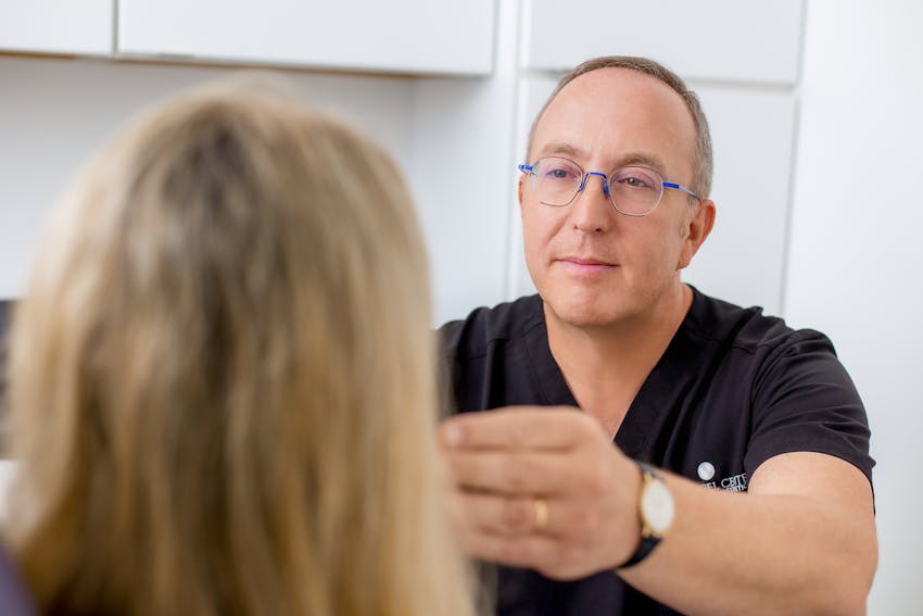 doctor examining patient's face