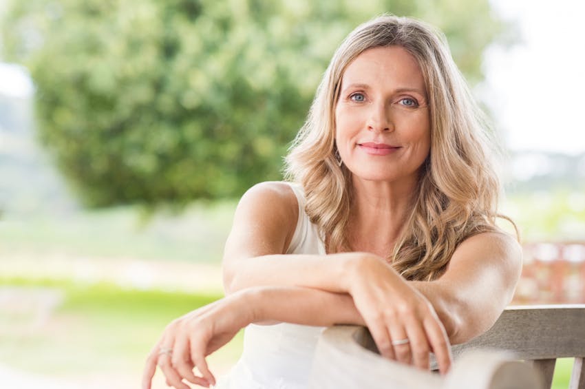 woman resting her arms on a railing
