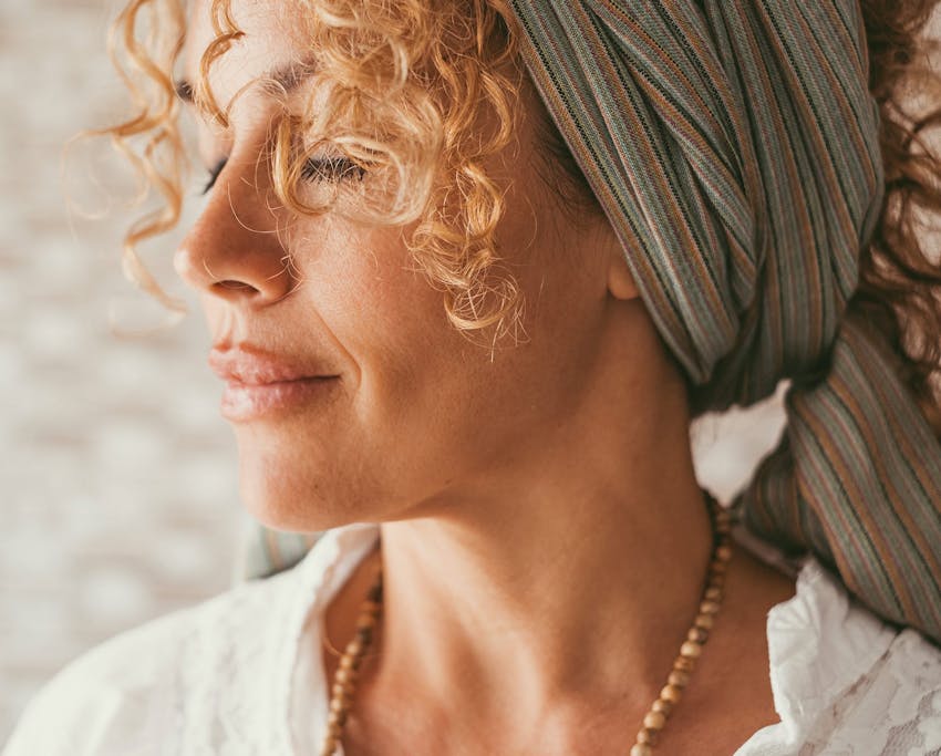 woman with her eyes closed with thick headband on