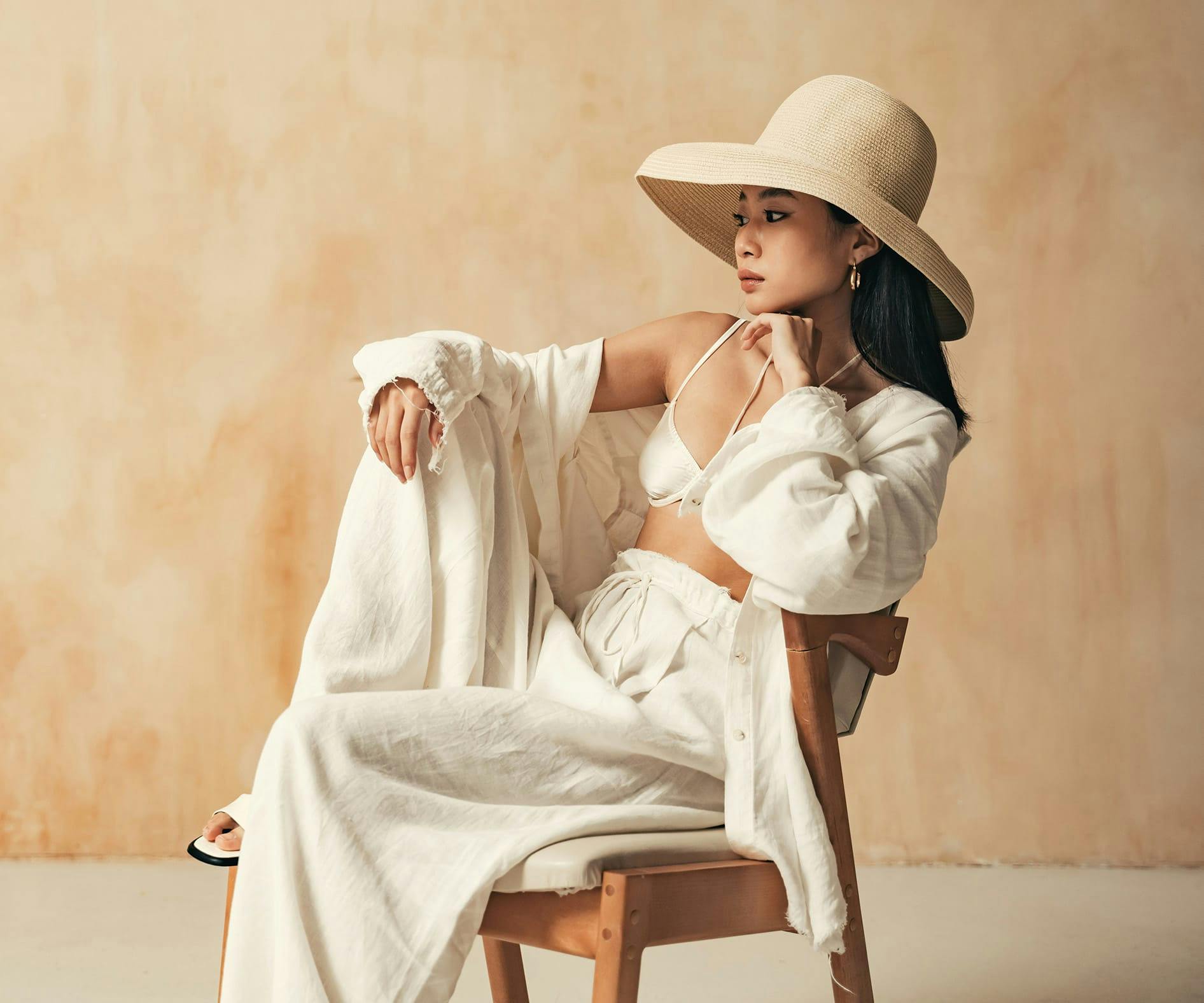 woman in white outfit sitting in chair
