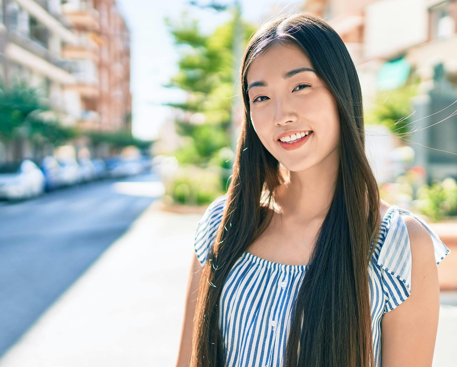 asian woman outside smiling