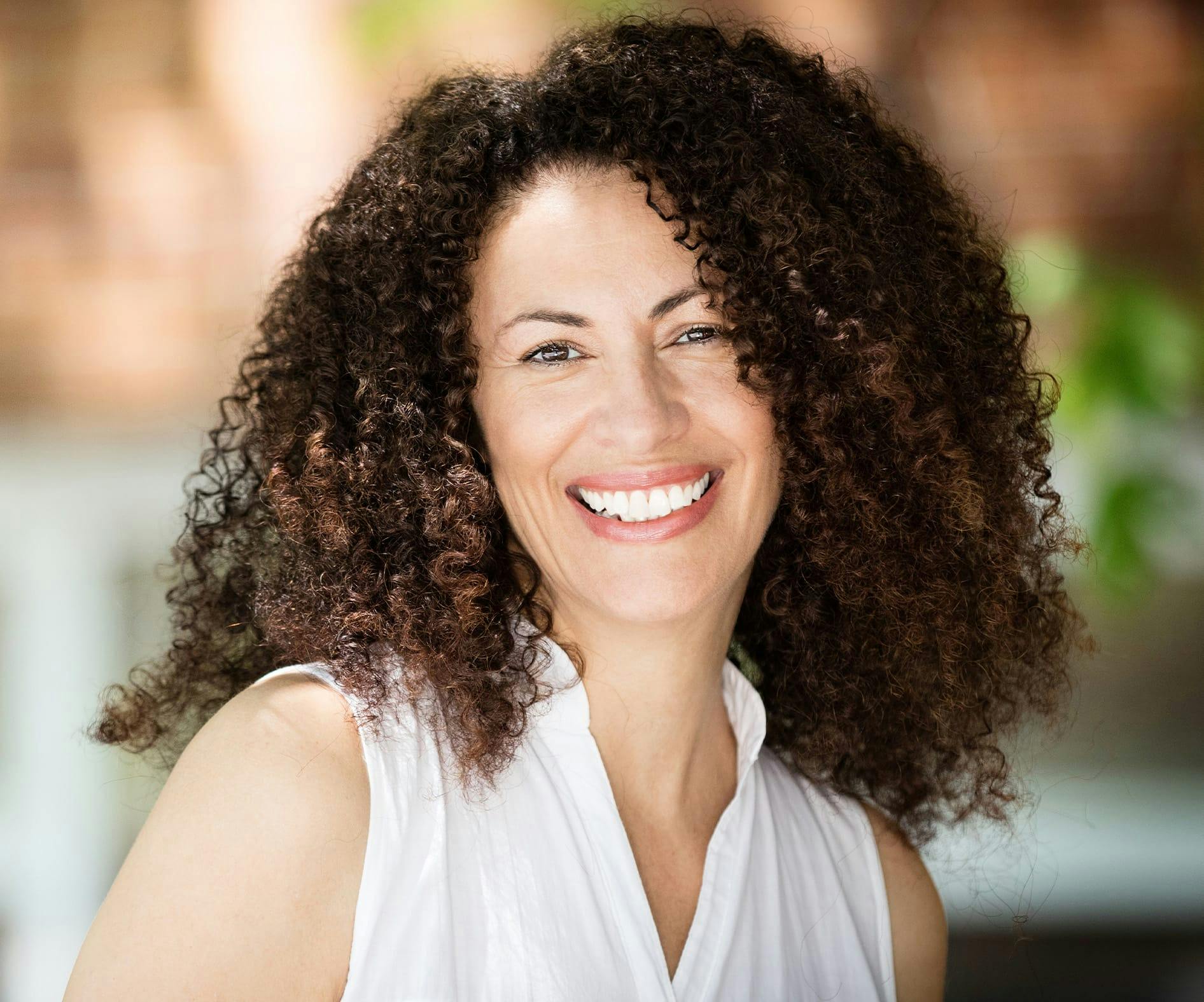 woman with curly hair smiling