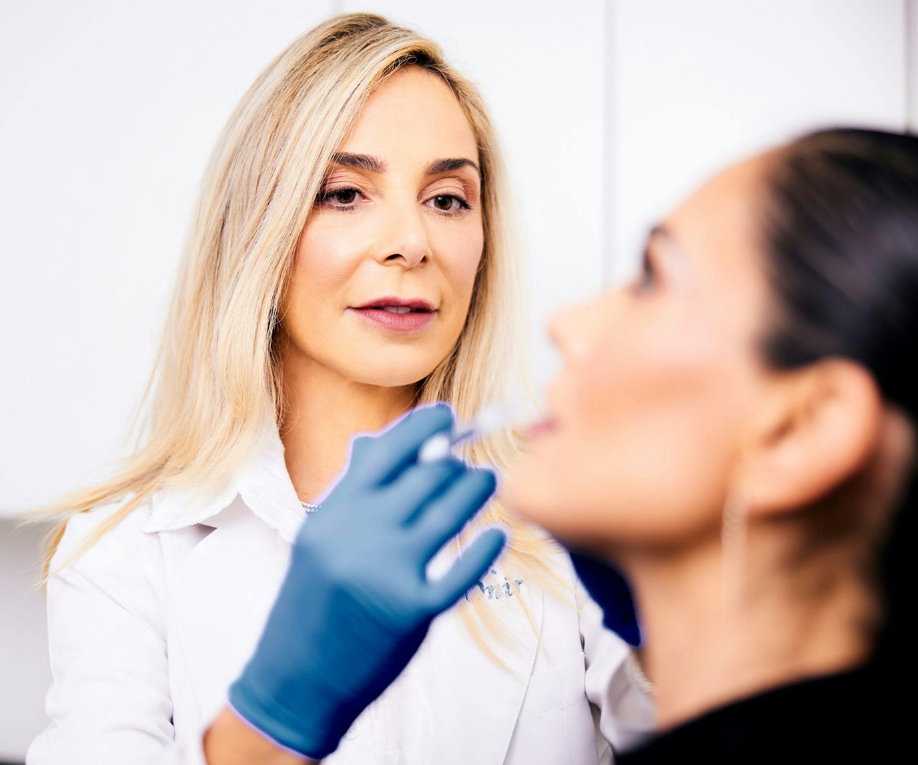Onir giving patient lip fillers