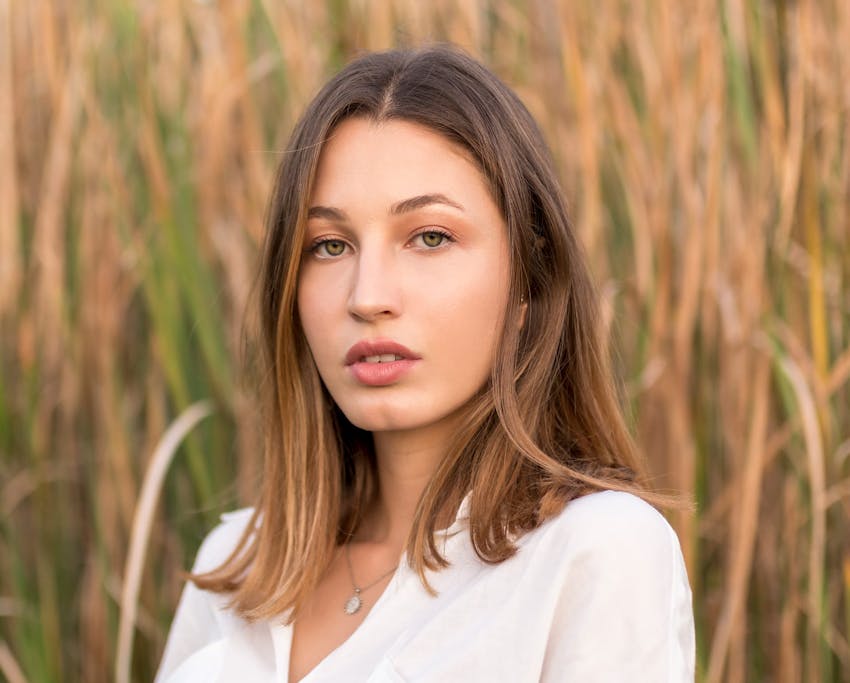woman looking forward while standing in a field