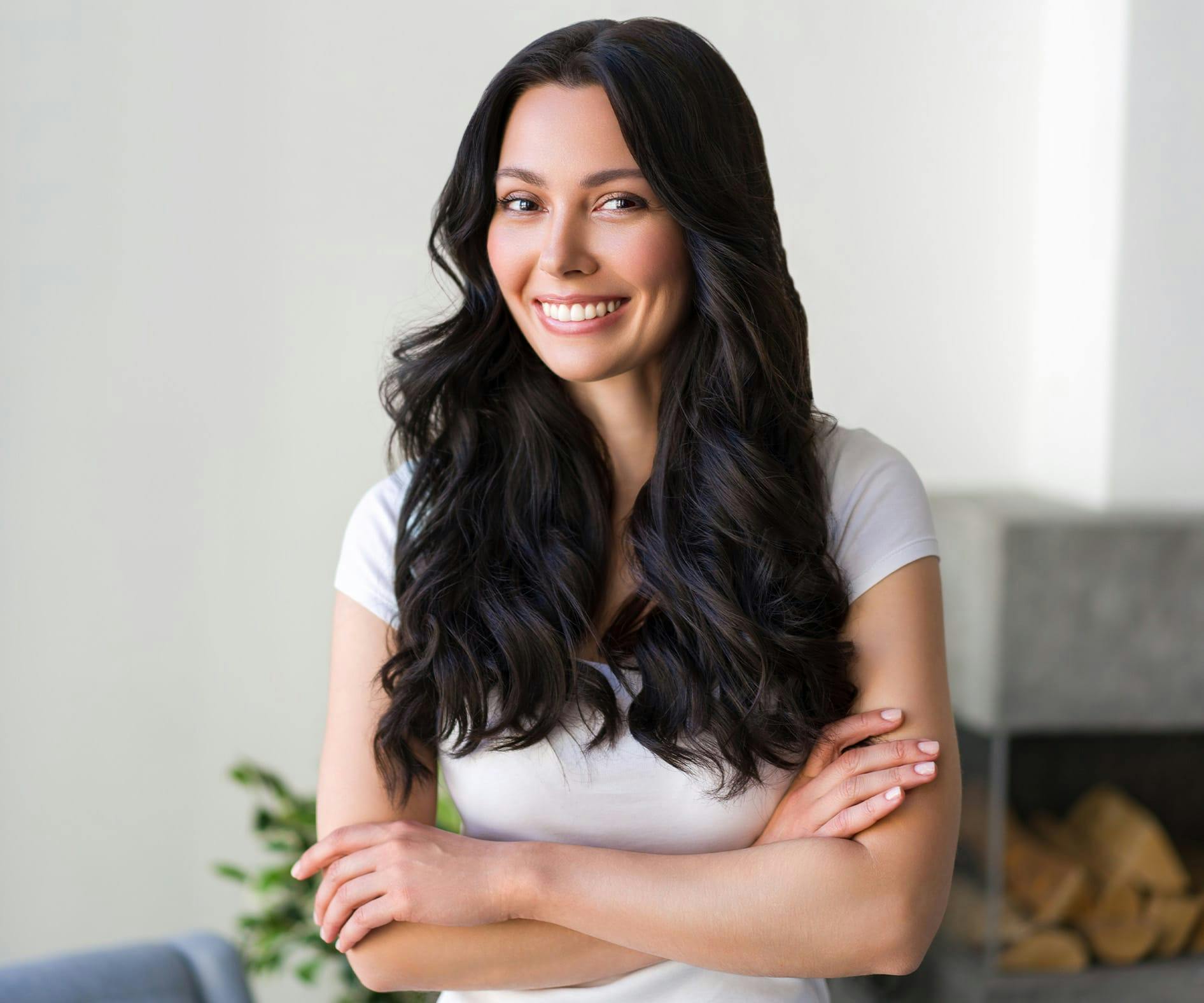 woman smiling while crossing her arms