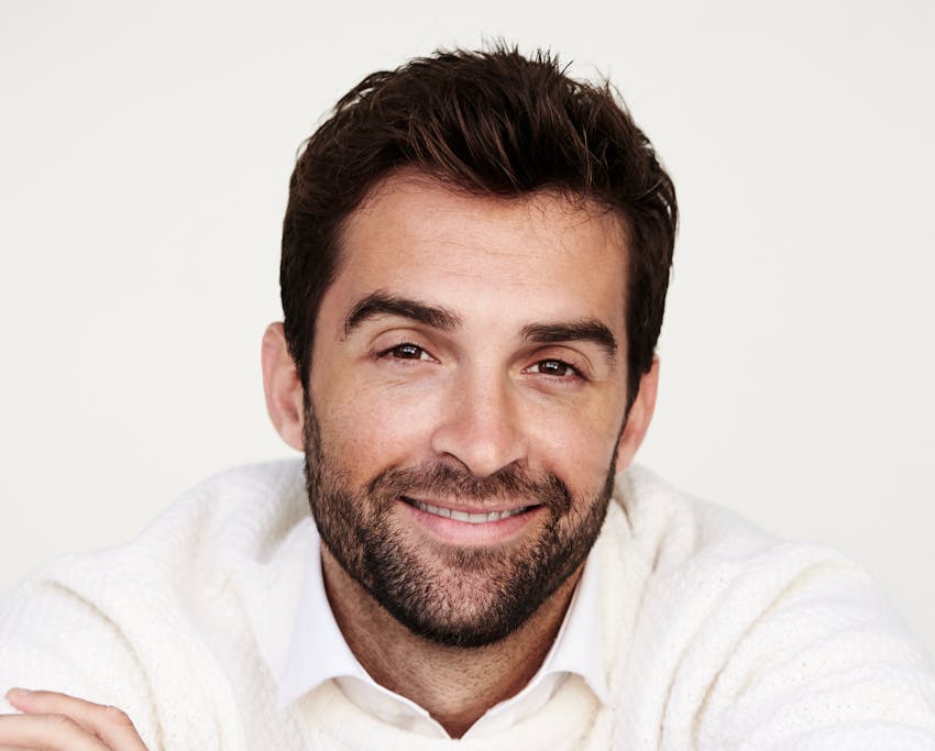 man smiling in white shirt