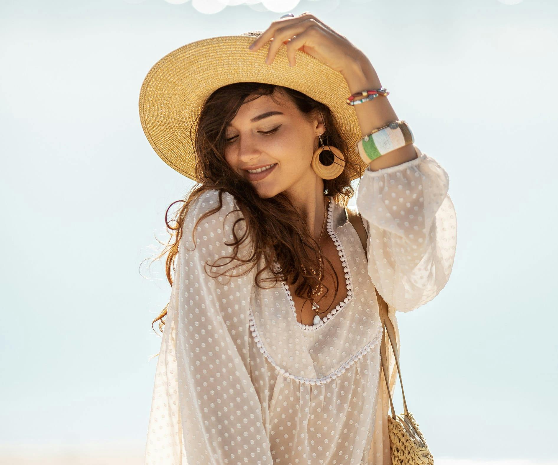 woman holding her summer hat