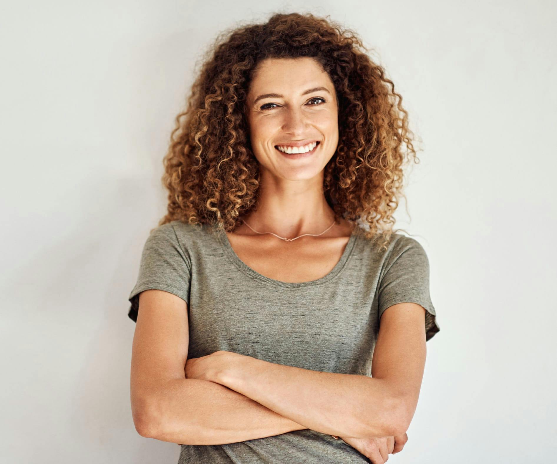 woman with curly hair smiling
