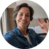 woman waving at webcam