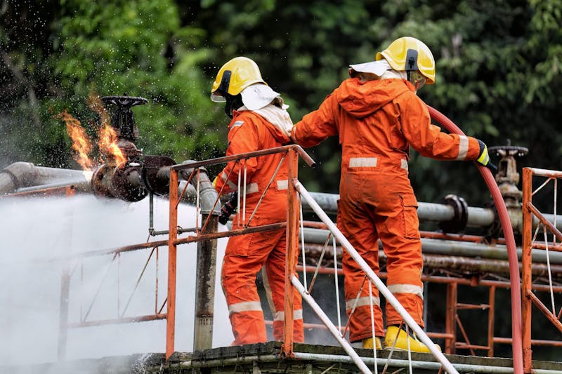 two workers in orange suits