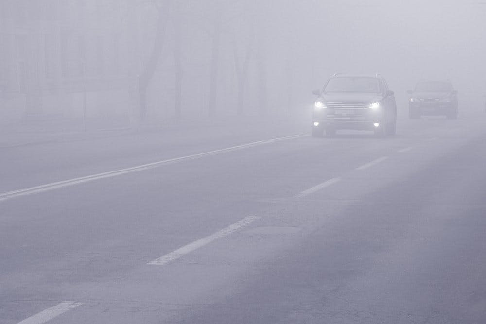 cars driving in the fog