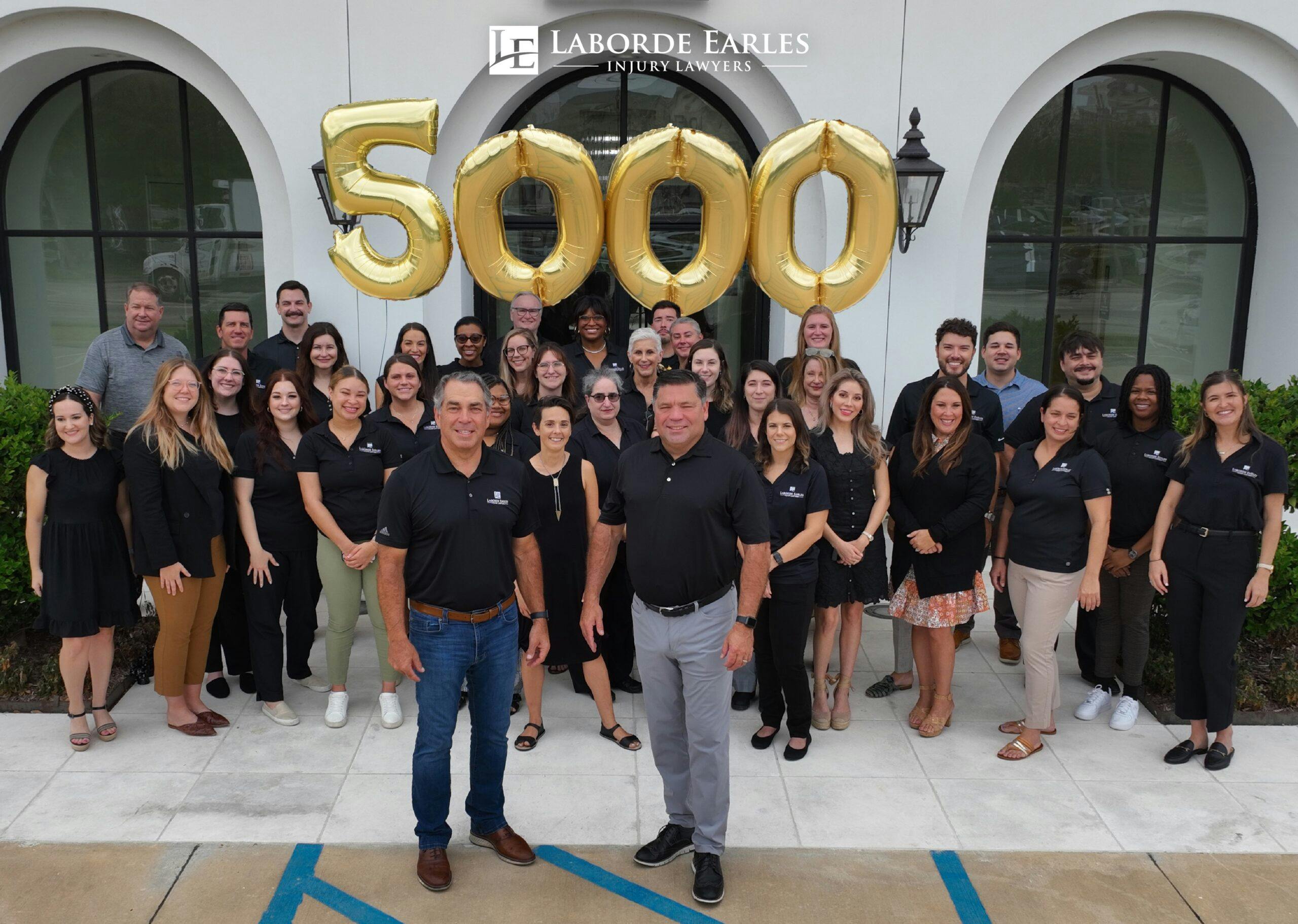 group standing in front up balloons