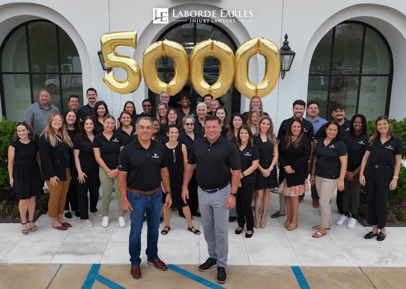 group standing in front up balloons