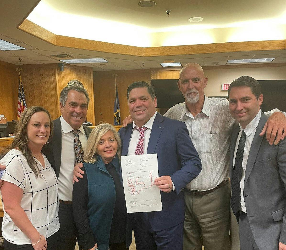 group holding up a piece of paper