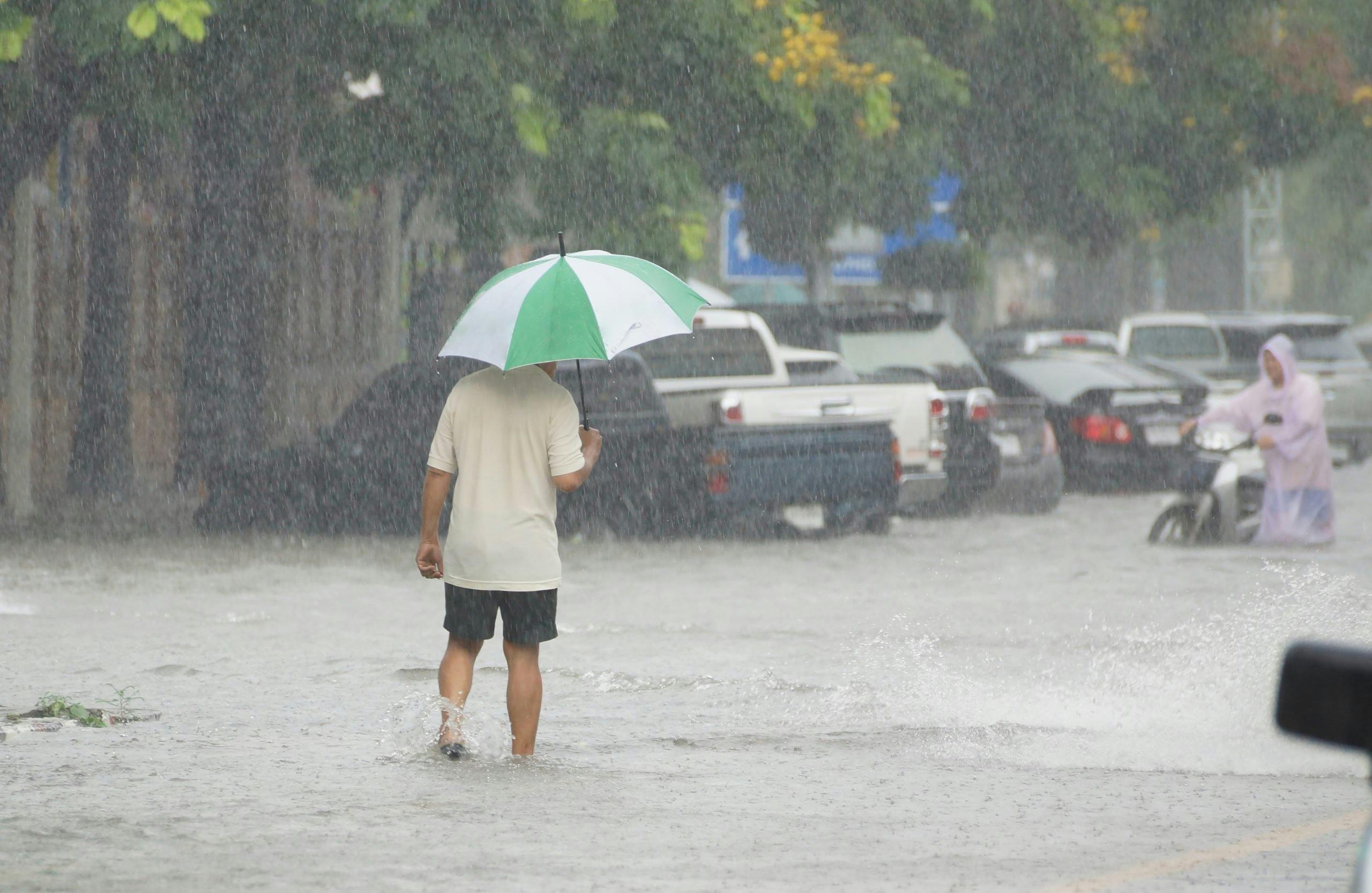 man holding umbrella in the rain