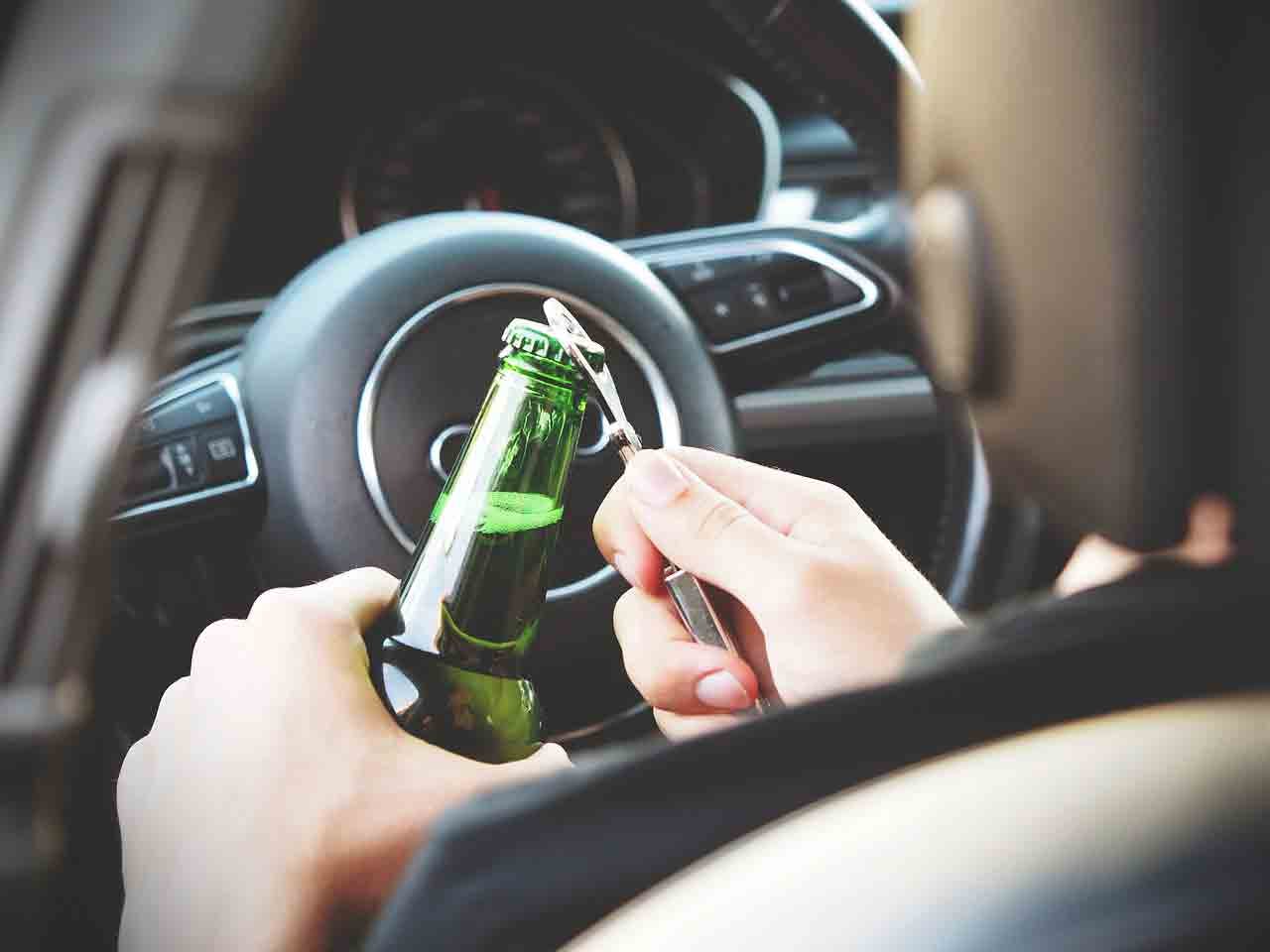 opening a beer behind the wheel