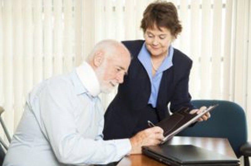 woman talking to man in neck brace