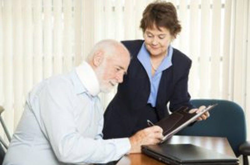 woman talking to man in neck brace