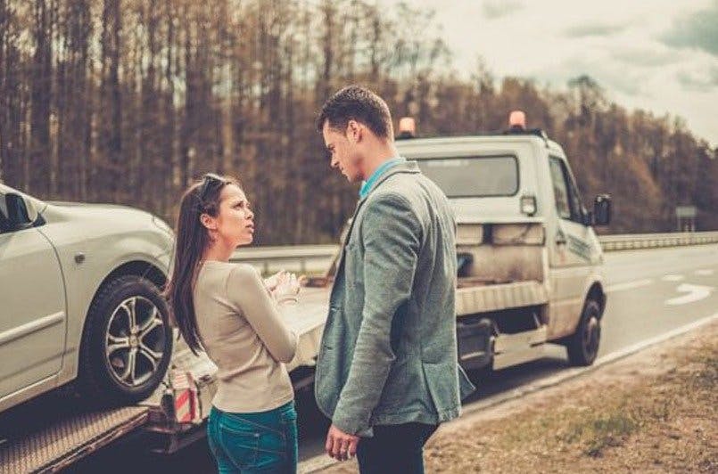 people watching car get towed