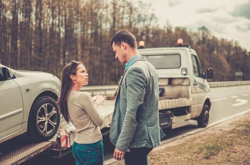 people watching car get towed