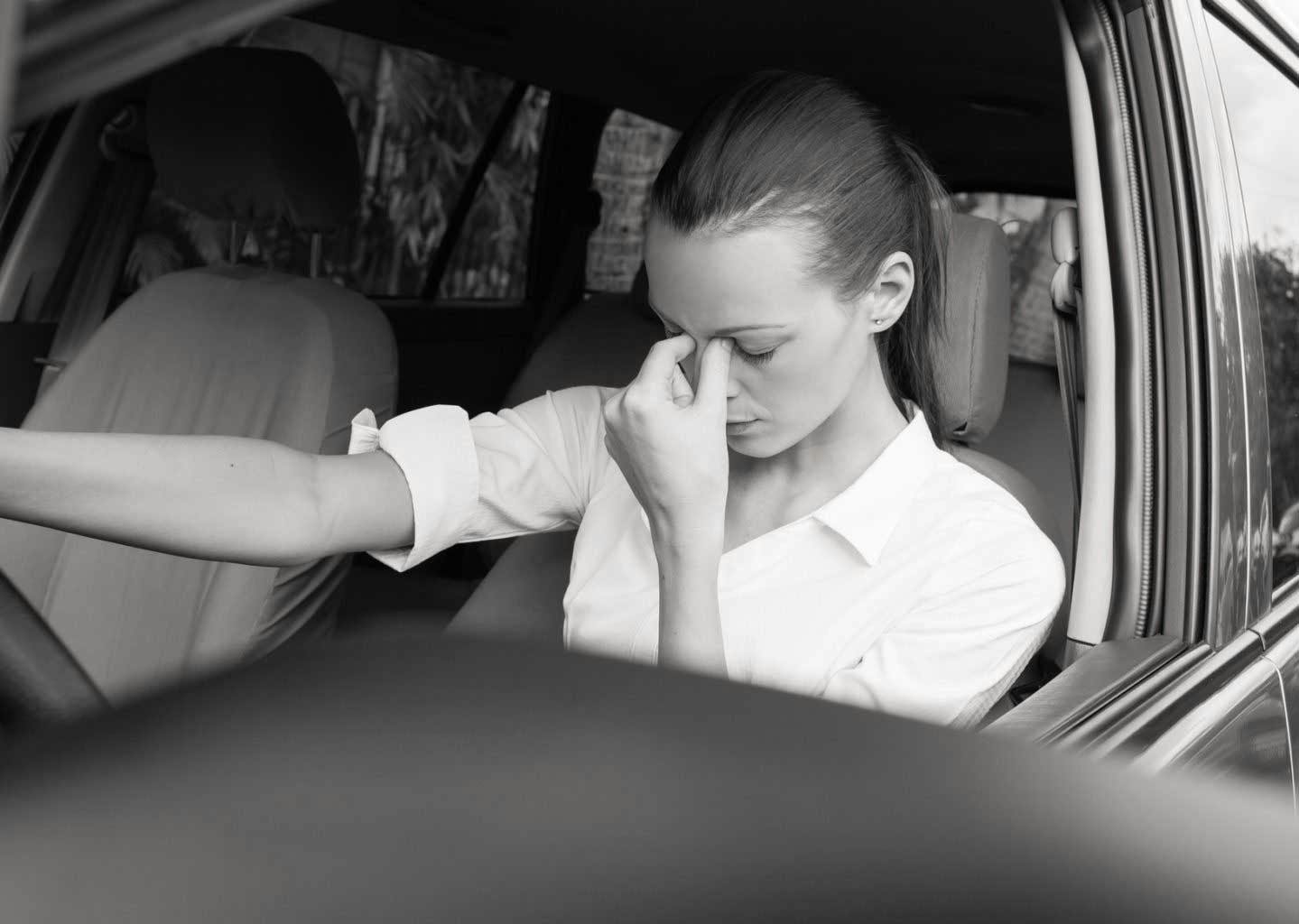 tired woman in a car