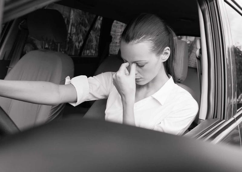tired woman in a car
