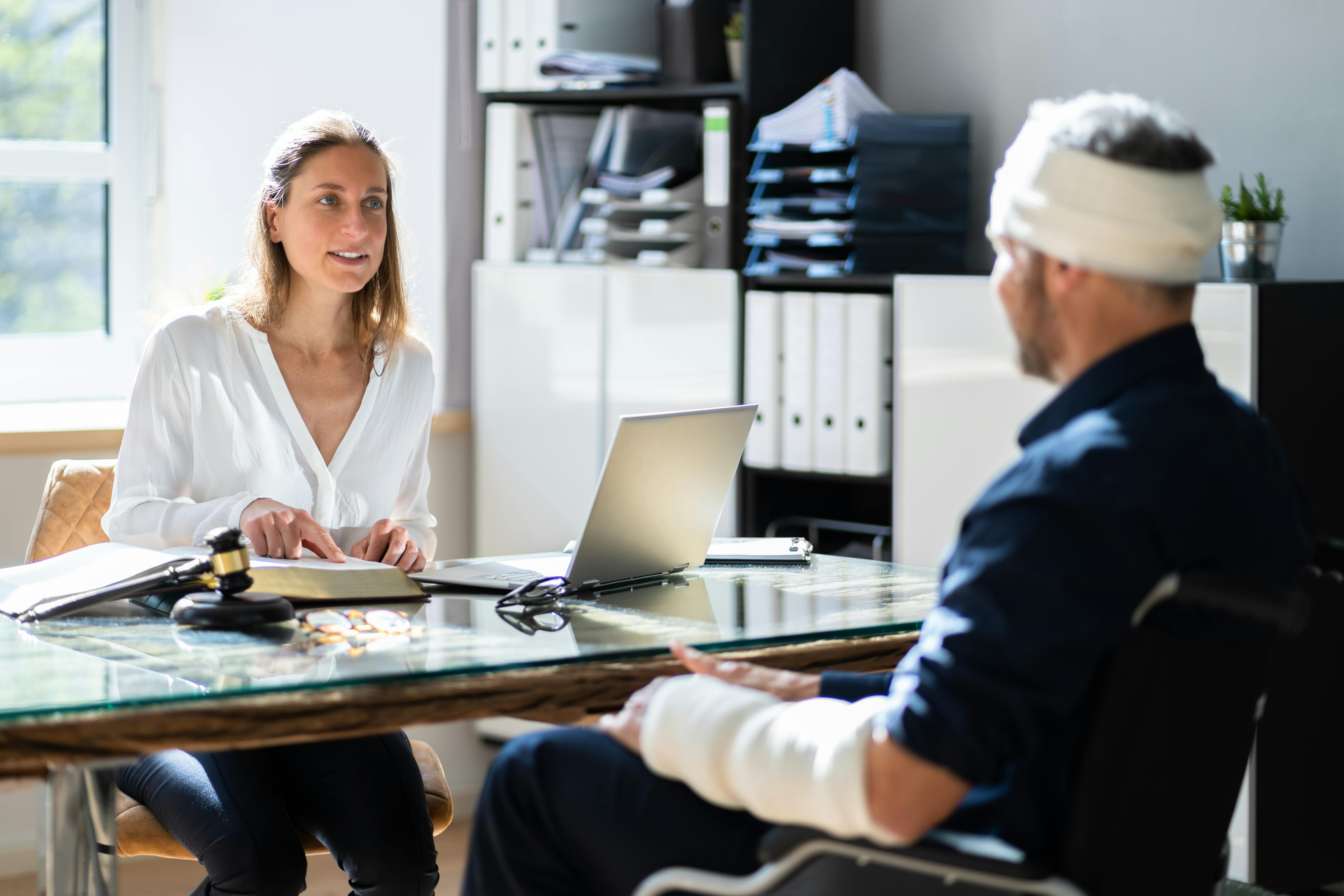 injured man talking to a lawyer