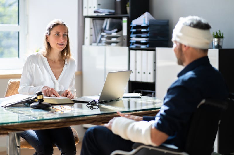 injured man talking to a lawyer