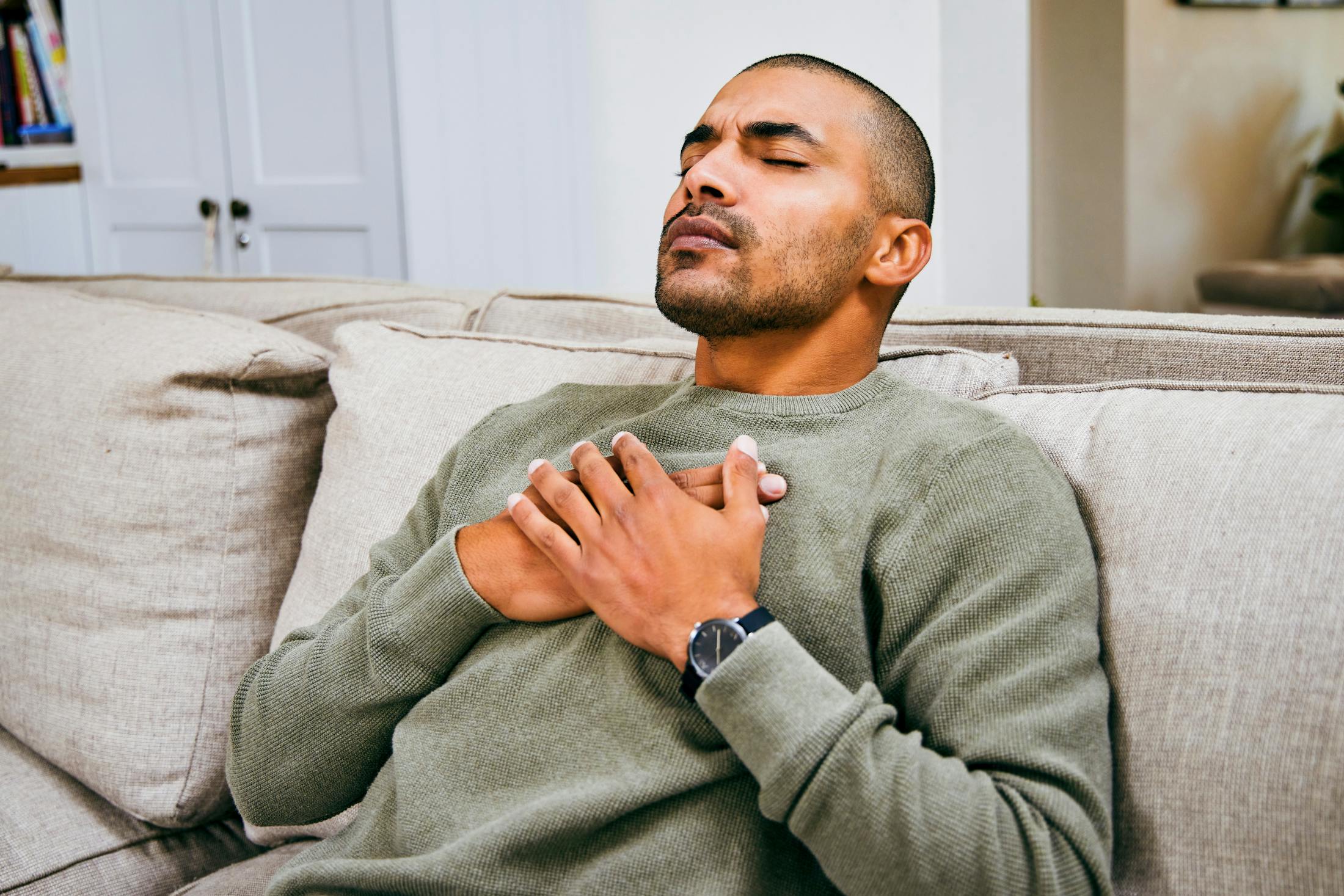 man holding chest