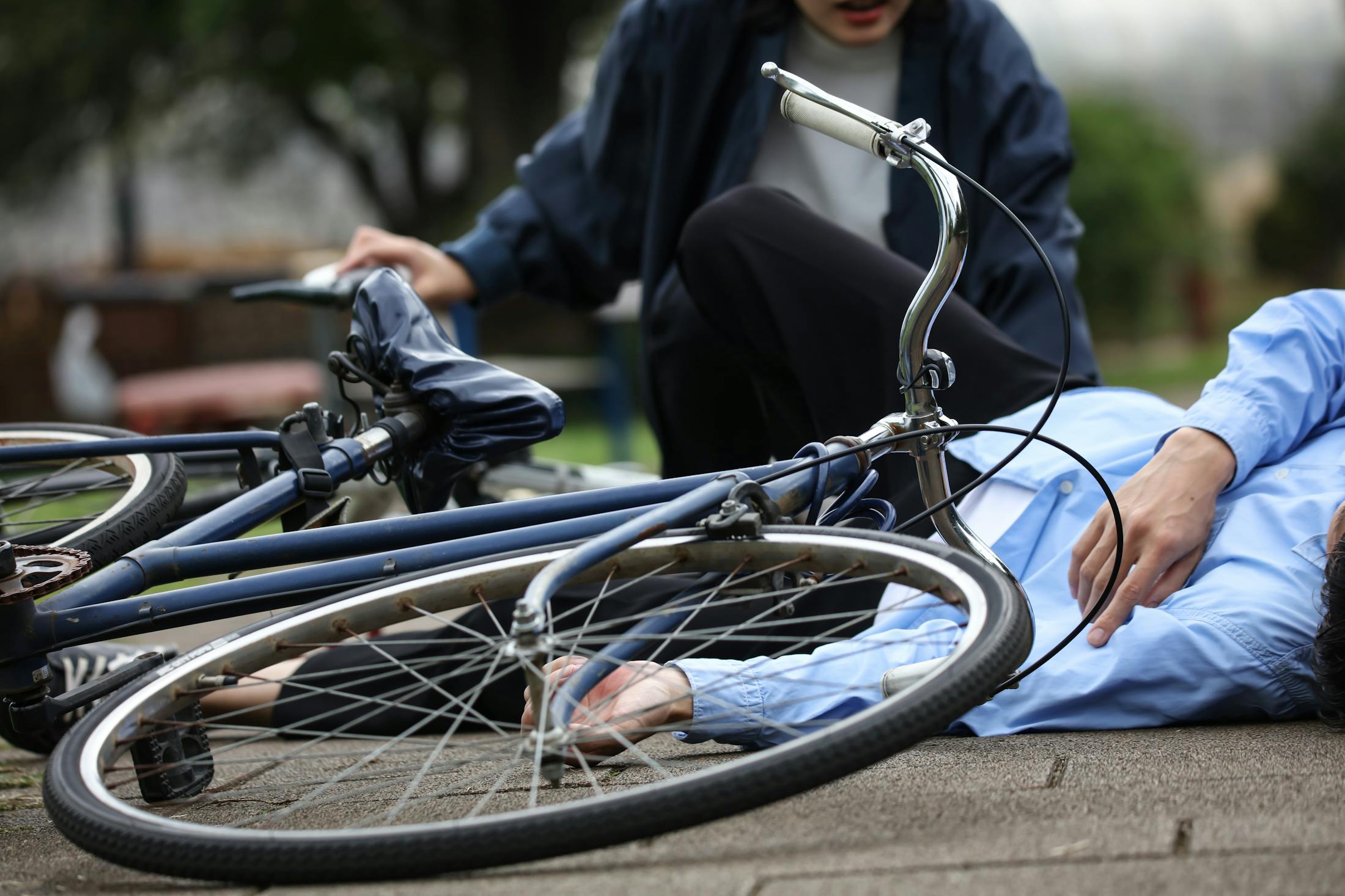 person on ground after falling off bicycle