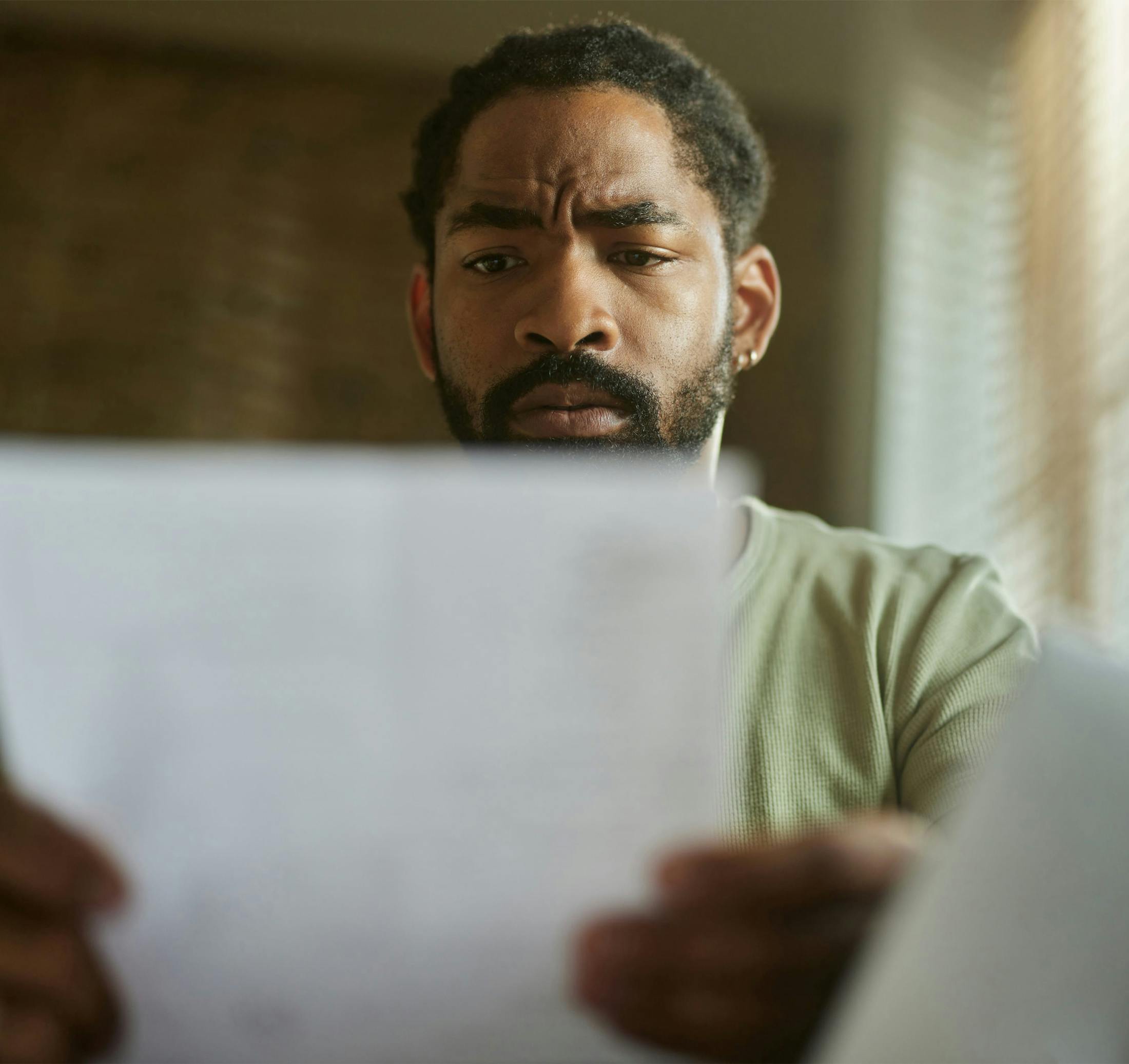 man looking at a paper