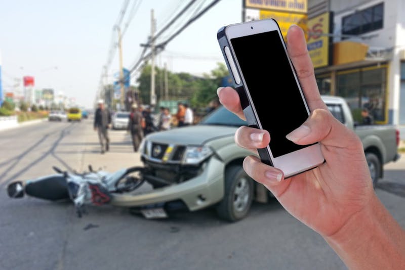 phone taking picture of car crash
