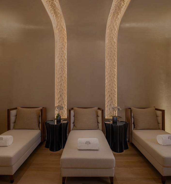 Premium spa beds with rolled towels and warm lighting