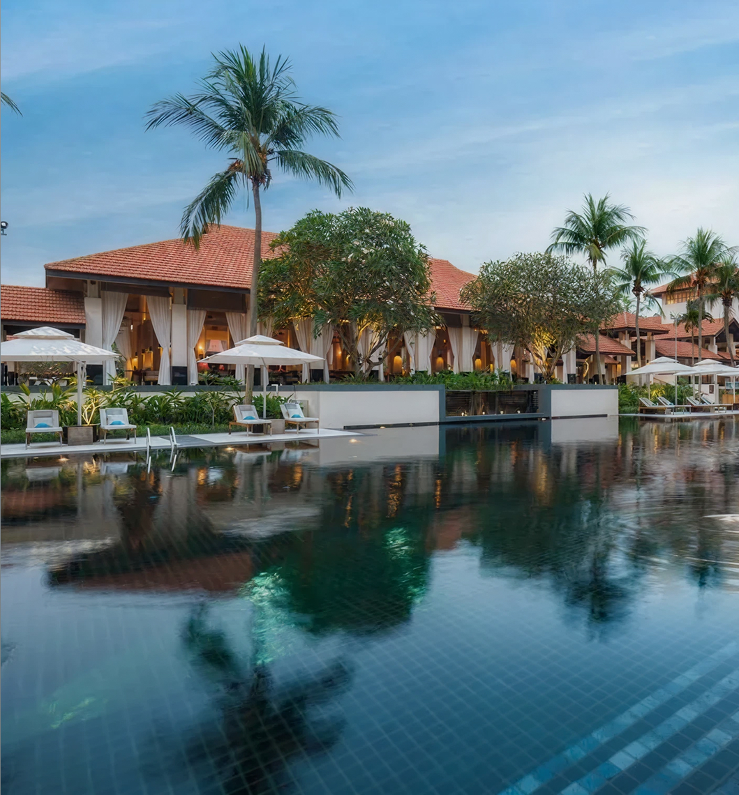 Large swimming pool infront of an asian style building