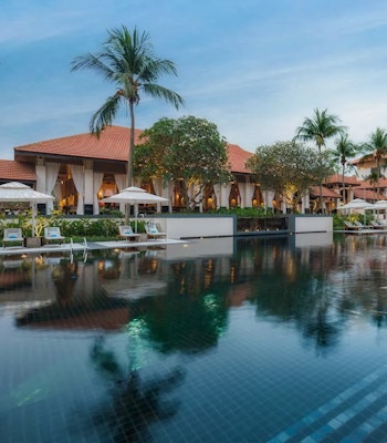 Sofitel Sentosa Singapore Pool Image Large swimming pool infront of an asian style building