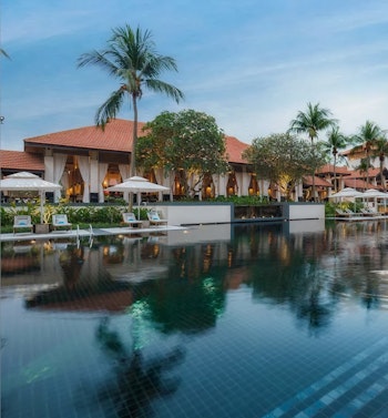 Large swimming pool infront of an asian style building