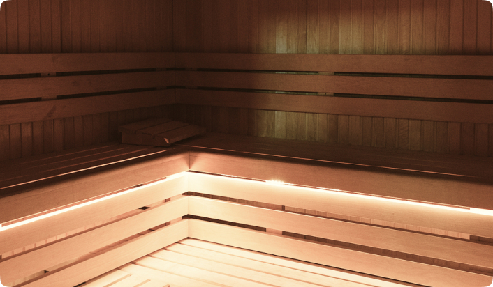 Wood panelled sauna with bright lighting