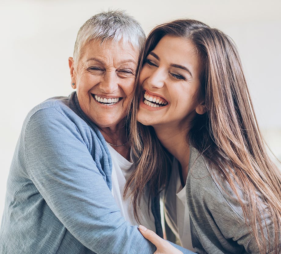 Mother and Daughter Hugging and Smiling