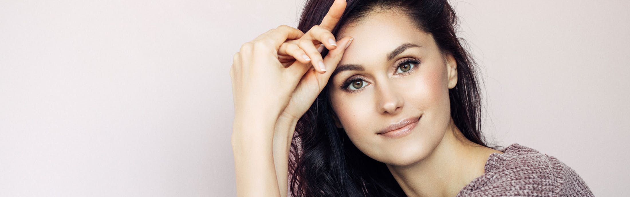 Women Smiling With Her Hands On Forehead